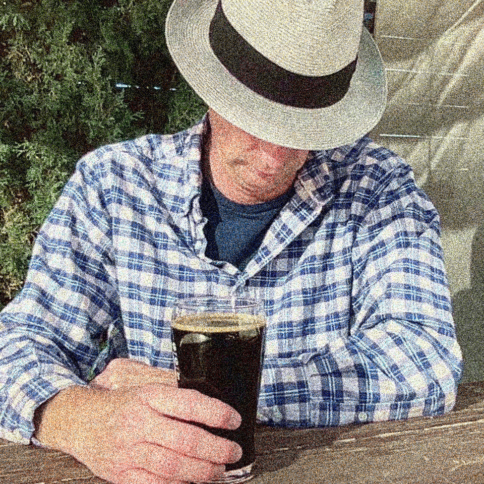 image of Ed Robins in a fedora with a beer